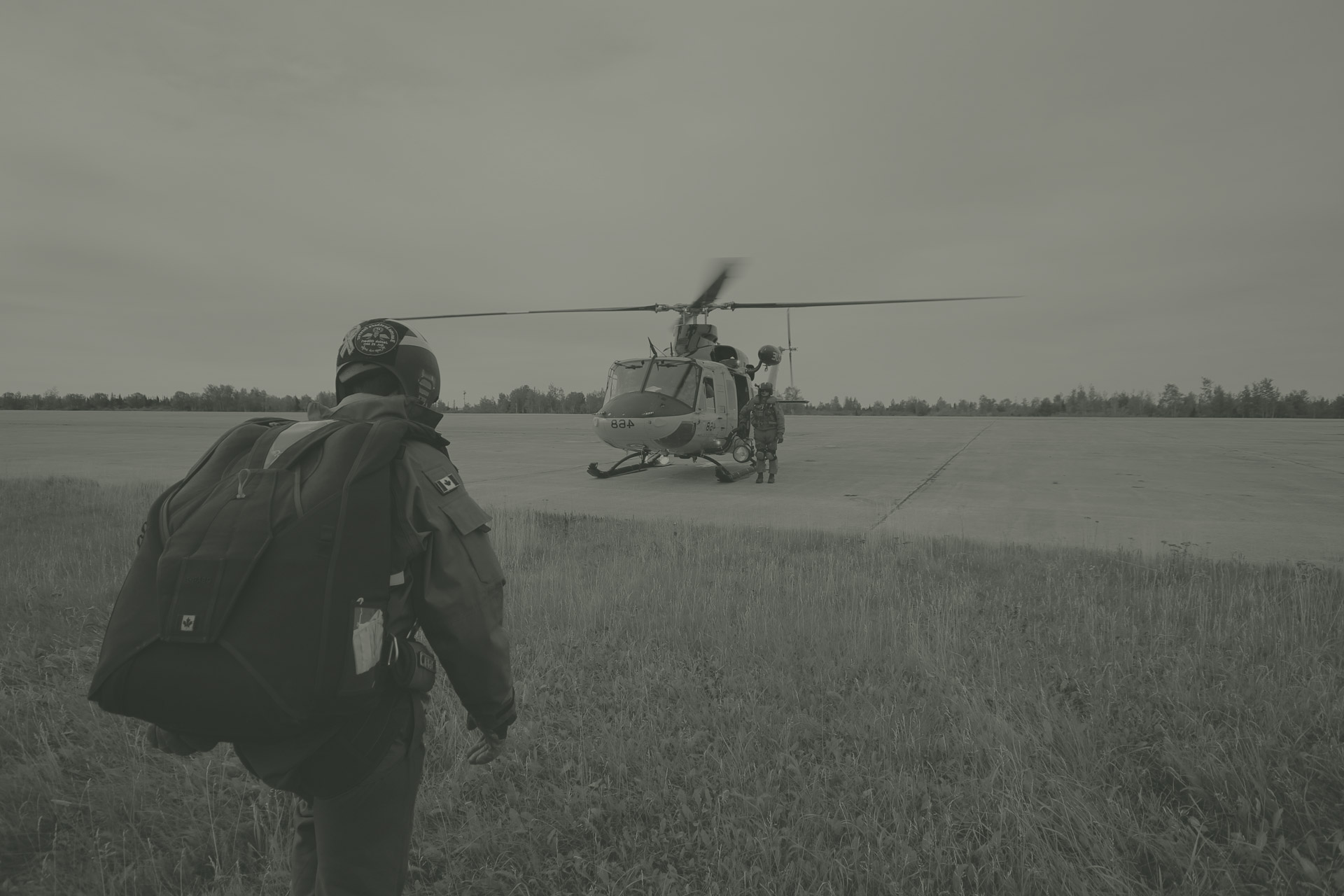 military-jumper-walking-toward-helicopter