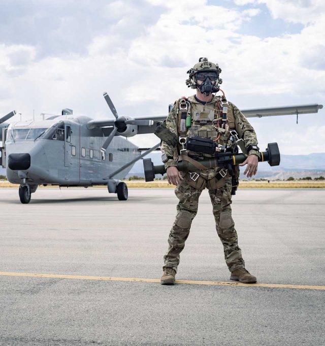 A military parachutist outfitted in military training equipment