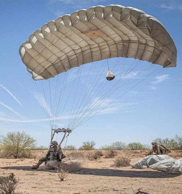 Military jumper landing Military Silhouette canopy in a desert region